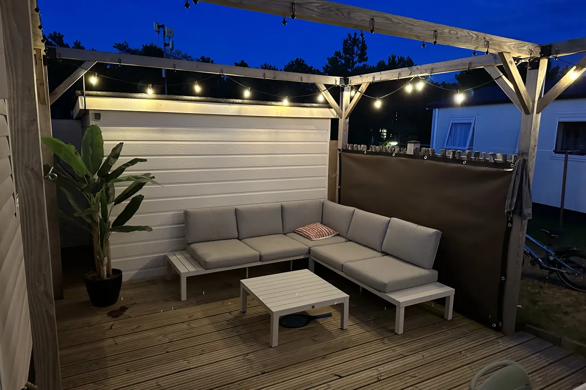 Terras met loungebank, hangmat en eettafel.